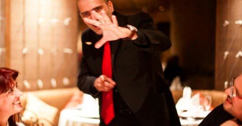 Maltese Magician Brian Role does magic for a dining couple and makes a coin float in close up magic.