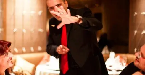 Maltese Magician Brian Role does magic for a dining couple and makes a coin float in close up magic.